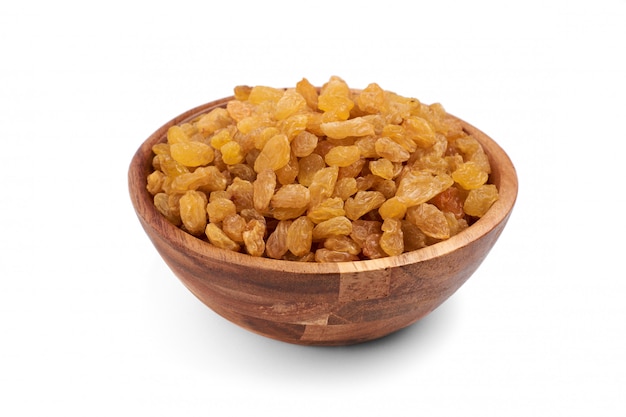 Dried raisins in wooden bowl