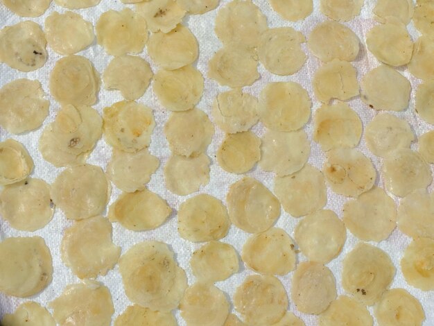 Photo dried raw melinjo chips. emping is made from flattened and seasoned melinjo fruit. emping mentah.