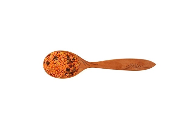 Dried Red Lentil and spices in wooden spoon. Masurdal or Dal Mix for soup mashed with curry.