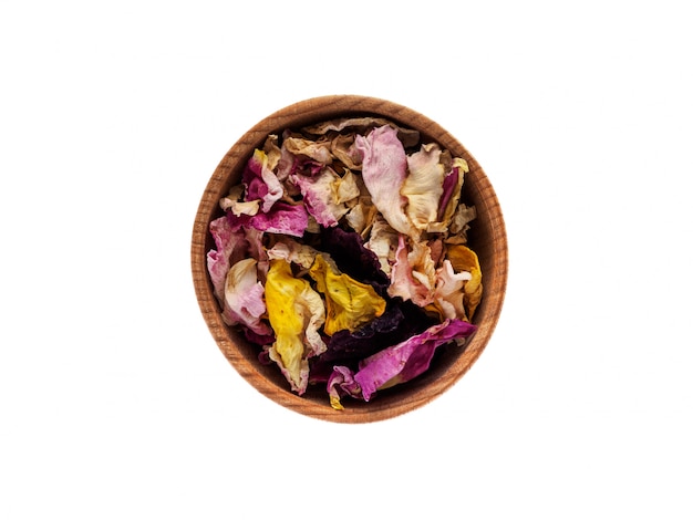 Dried rose petals in a wooden Cup on a white 