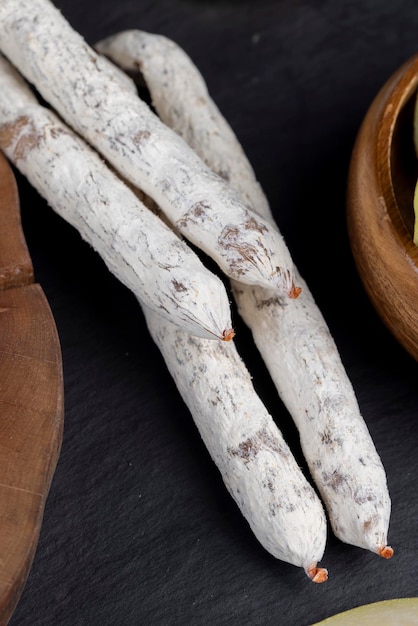 dried sausage with white mold cut into small pieces thin pork sausage covered with edible mold