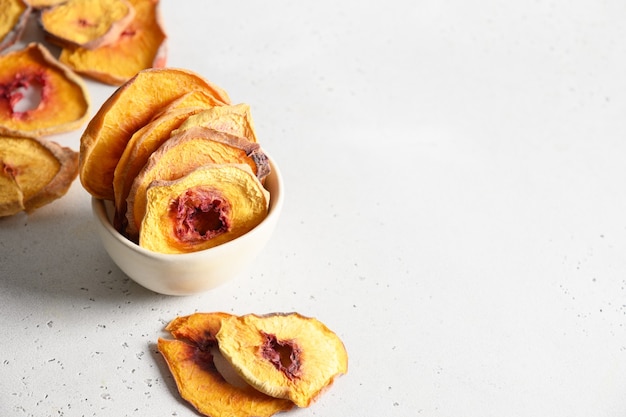 Dried sliced peach in bowl for home drying