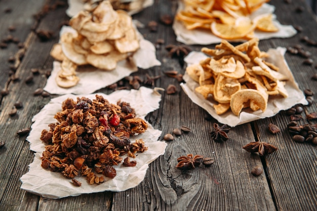 Dried slices of orange, apple, bananas and pear on paper