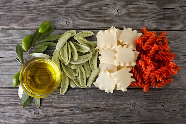 Dried spaghetti in Italian flag colors and olive oil