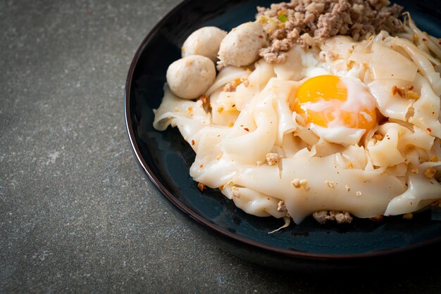 dried spicy noodles with minced pork, meatballs and egg - Asian food style