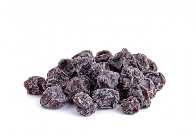 Dried sweet black plums isolated on white 