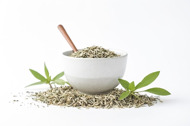 Dried tea leaves in a bowl with green leaves