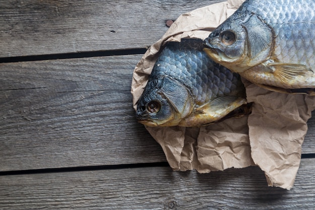 Dried Volga bream vobla in a crumpled kraft paper roll, delicious beer snack