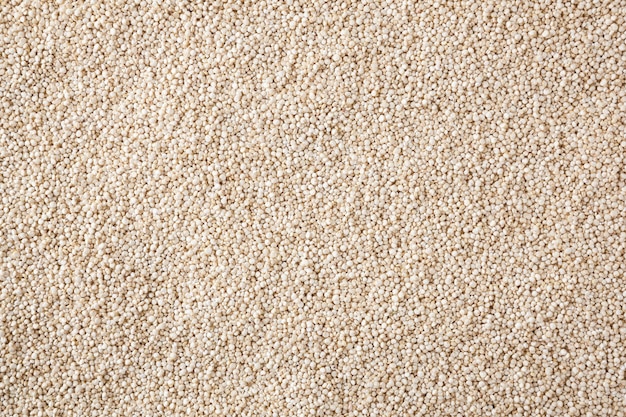 Dried white quinoa seeds background