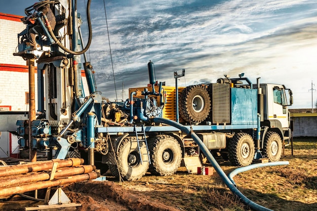 The drilling rig closeup is drilling a well against the background of the cloudy sky Deep hole drilling Geological exploration work mineral exploration Extraction of gas and oil