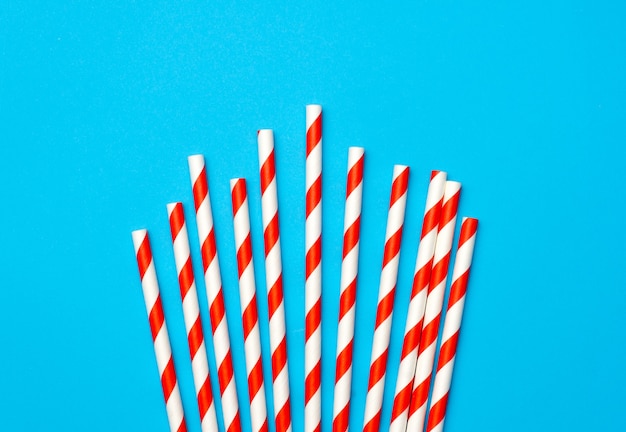  drinking straws on blue background