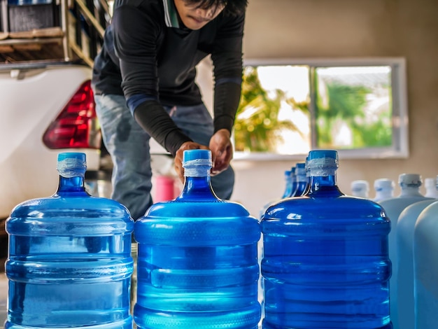 Drinking water clear and clean in blue gallon arranged in a row Prepare to lift small business