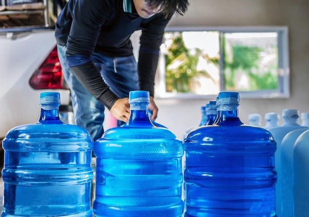 Drinking water clear and clean in blue gallon arranged in a row Prepare to lift small business