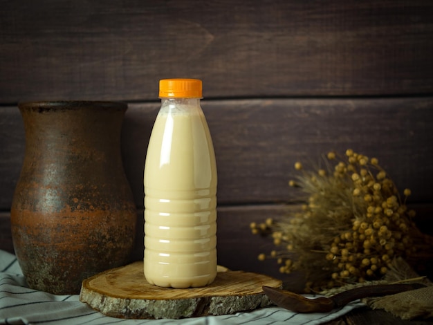 drinking yogurt in a plastic bottle on a rustic background minimalism copy space