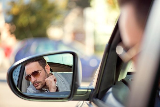 Driver in rearview mirror