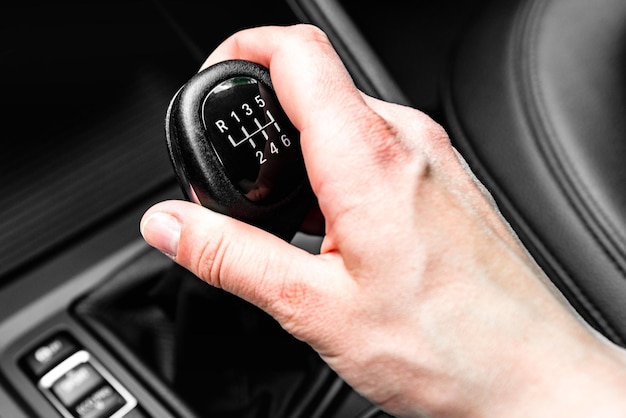 Driver shifting the gear on car manual gearbox.