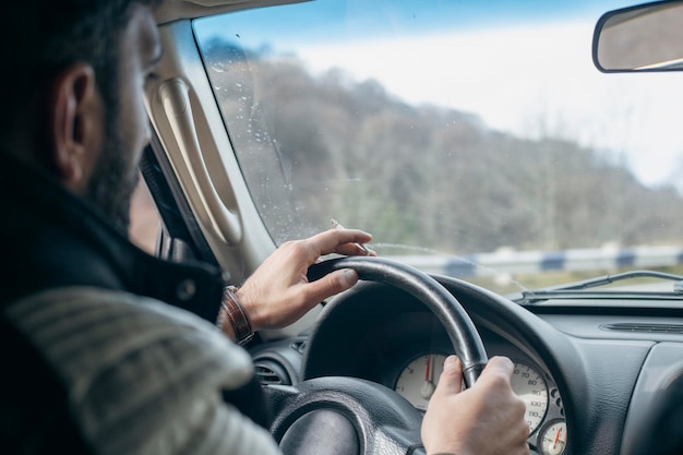 The driver smokes a cigarette while driving