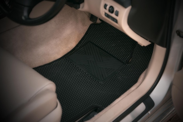 Driverside black floor mats made of ethylene vinyl acetate shortened for EVA Dark floor mats in the light interior of the car