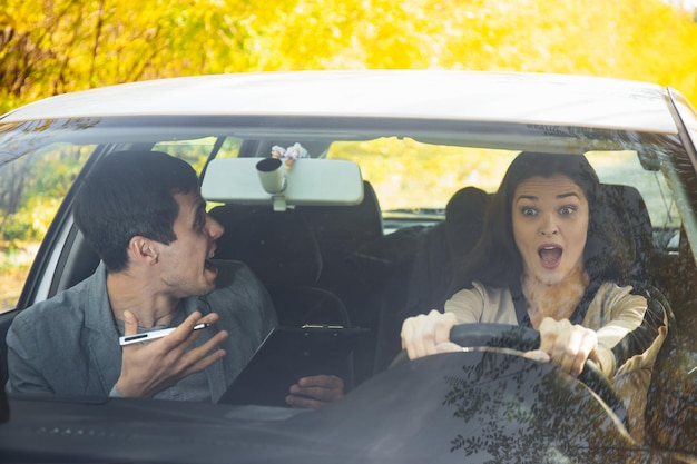 A driving instructor yells at a student girl at the wheel Got into an accident