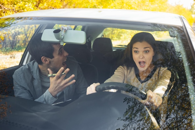 A driving instructor yells at a student girl at the wheel Got into an accident