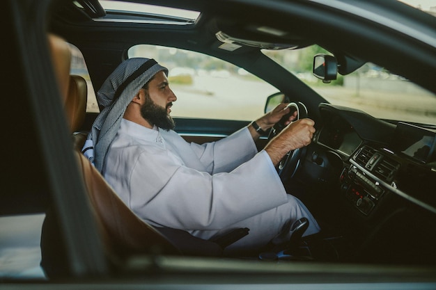 Driving Saudi man driving a car and feeling good