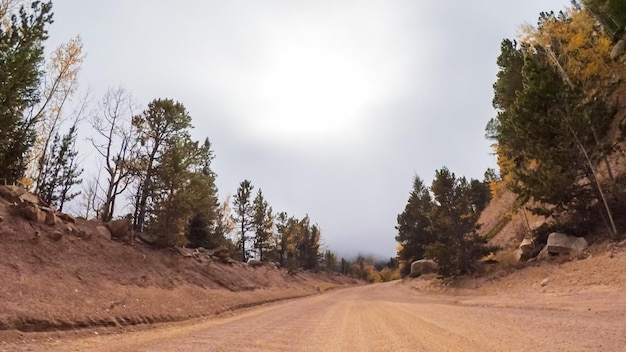 Driving on small mountain dirt roads from Colorado Springs to Cripple Creek in Autumn.