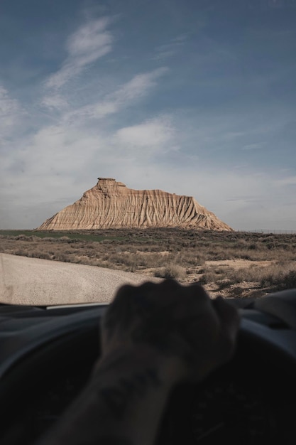 Driving through a desert in the background a rocky mountain Selective focus