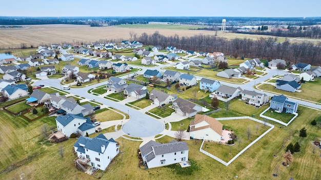 Drone aerial of suburban Midwest American neighborhood houses with ponds and housing addition and culdesac