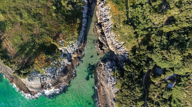 Drone aerial view of the cantabric sea coast Cliff on the coast with turquoise sea on a sunny summer day