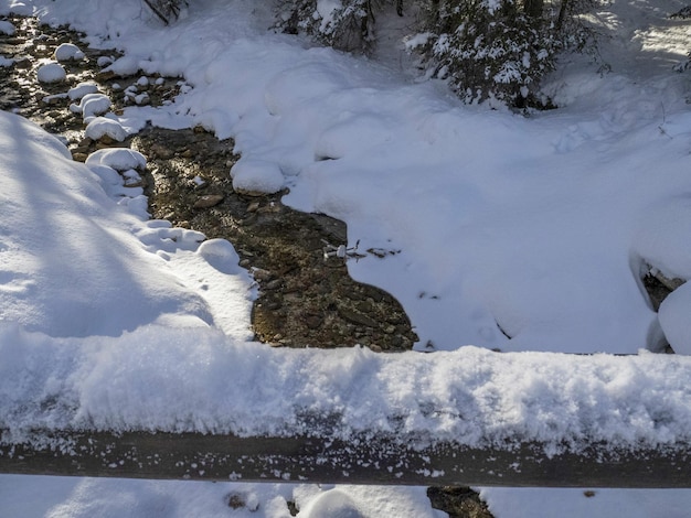 Drone on dolomites snow panorama wooden hut val badia armentarola creek