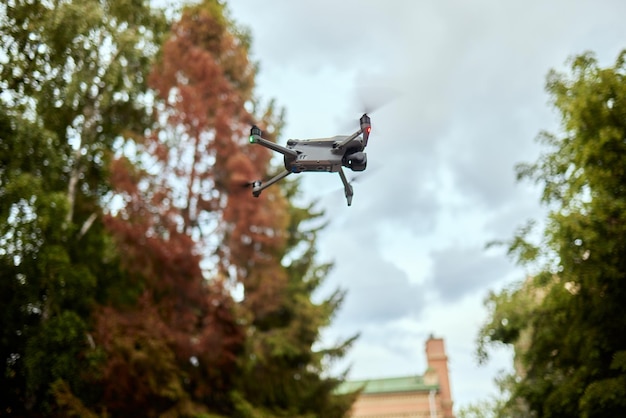 Drone flying overhead in cloudy blue sky