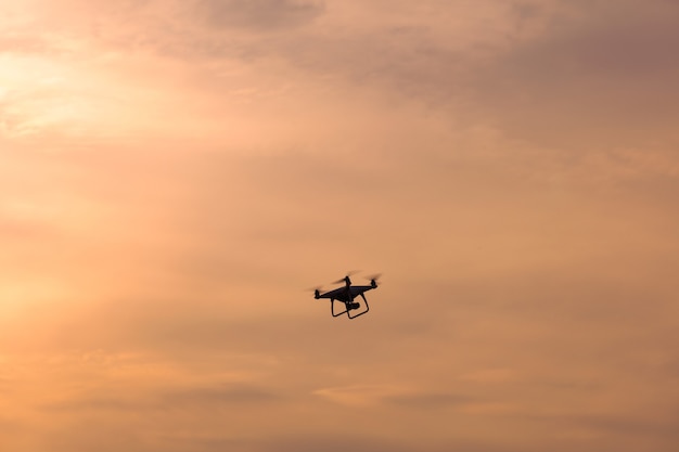 Drone Flying in The Sky at Sunrise