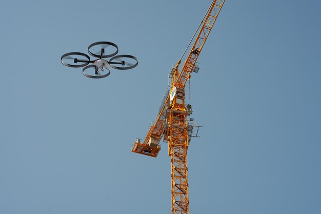 Photo drone inspecting a construction crane