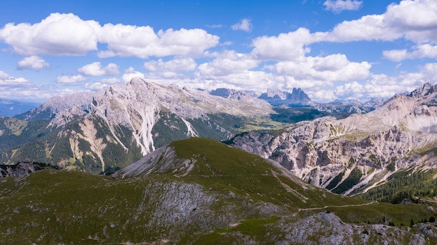 Drone photo Alpine mountains in the Dolomites Italy High cliffs blue sky clouds