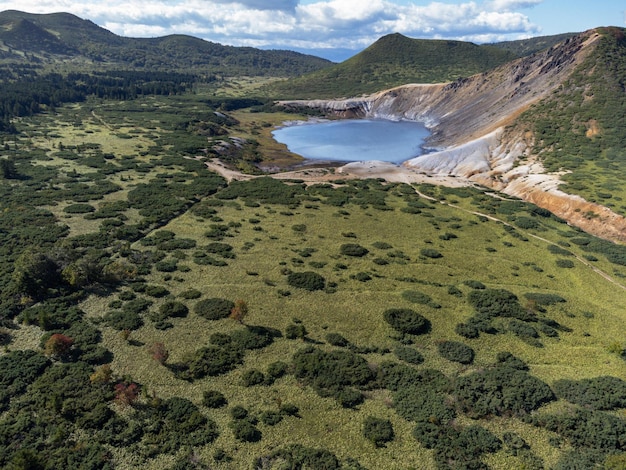 Drone point of view the Boiling lake in caldera of Golovnin volcano on Kunashir Island, Kurils, Russia.