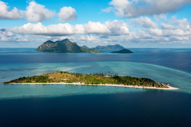 Drone point of view of tropical island Maiga near Tun Sakaran Marine Park