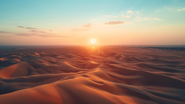 A drone shot of a vast desert landscape with rolling sand dunes and the sun setting on the horizon