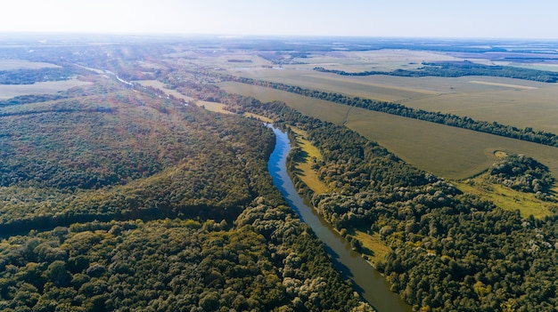 Drone with a camera, beautiful summer small river from a height