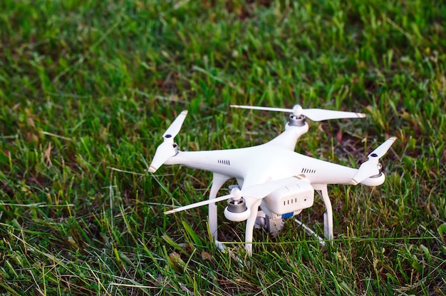 Drone with camera in the grass preparing to fly