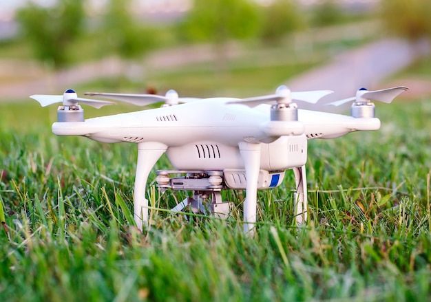 Drone with camera in the grass preparing to fly