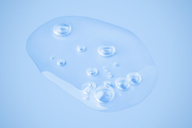 A drop of clear gel A swab of gel Smear Gel On a blue background Hyaluronic acid toner toner gel cream Cosmetics