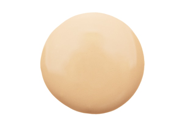 A drop of nude matte foundation isolated. Powdery texture of a beauty makeup liquid fluid for face contouring. Smeared sample of beige women's skincare product.