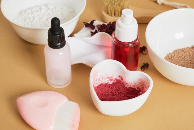 Dropper bottle serum tonic spray bottle and dried hibiscus flower petal powder natural ingredients for DIY