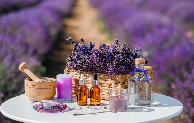 Dropper bottle with lavender cosmetic oil or hydrolate against lavender flowers field as background with copy space Herbal cosmetics and modern apothecary concept