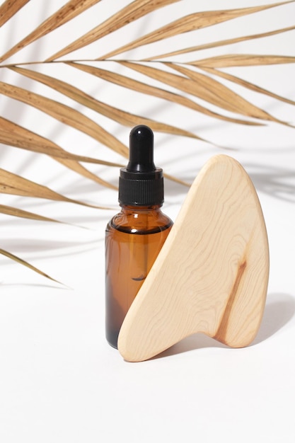 Dropper cosmetic oil bottle and wooden Chinese Gua Sha massage tool with dry palm leaf Natural organic cosmetic eco lotion essence serum Aromatherapy