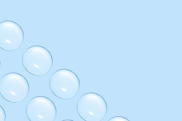 Drops of clear gel or water in rows On a blue background