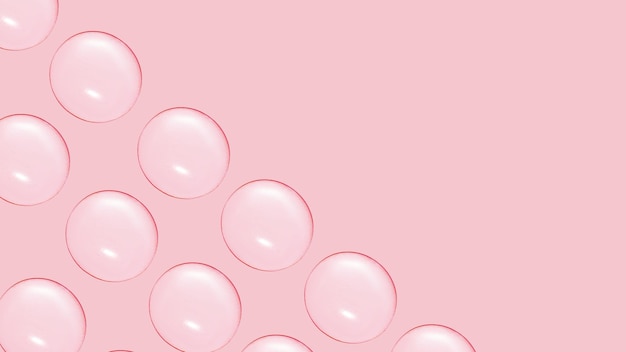 Drops of clear gel or water in rows On a pink background