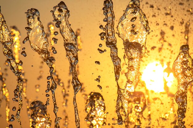 drops of the fountain in the setting sun