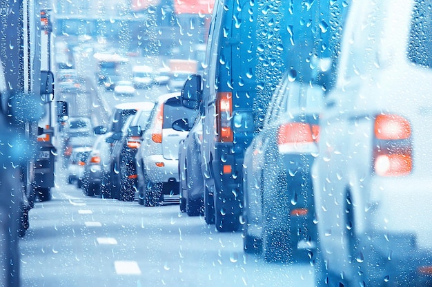 drops on glass auto road rain autumn night / abstract autumn background in the city, auto traffic, romantic trip by car