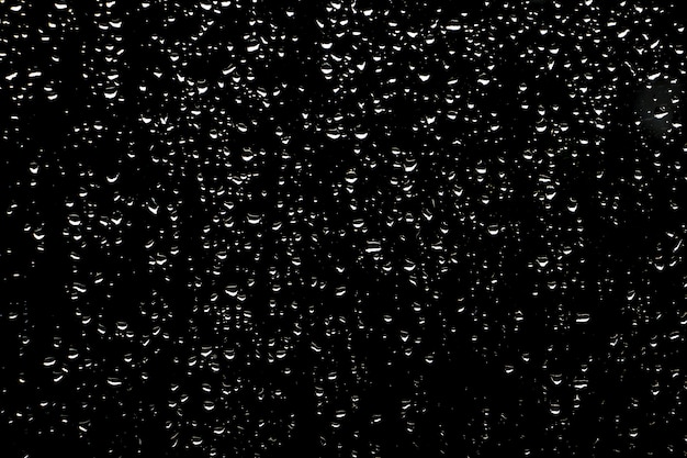 Drops of rain on dark glass background